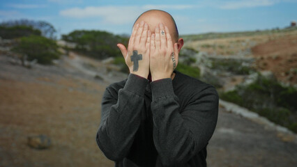 Bearded man with tattoos performs gestures outdoors in a scenic park setting showcasing playful...
