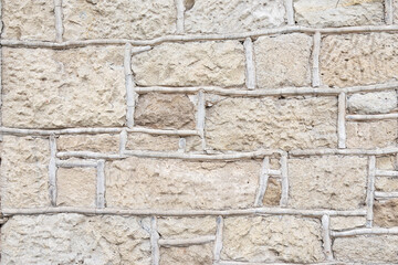 External wall of an old building, the material used is clay and wood which is evident in the image