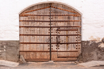old big door with rusty iron strips