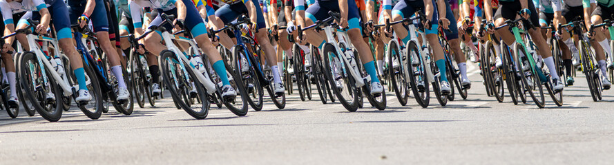 Professional cyclists in vibrant uniforms racing outdoors during a high-energy competition with...