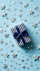Obraz premium Gift Box Surrounded by Silver Stars on a Blue Background for Special Occasions