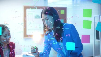 A woman is writing on a whiteboard with a green marker. The board has a lot of numbers and equations, and the woman is writing on it. Scene is focused and serious - Powered by Adobe