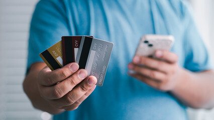 Handing over multiple credit cards online payment shopping scenario indoor setting close-up view