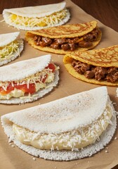 Delicious Tapioca Pancakes with Various Toppings - Assortment of savory tapioca pancakes with diverse fillings like cheese, meat, and tomato sauce. Perfect for a quick and tasty meal