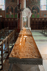 Burning candle ritual in Greek church Altar with luminous offerings in Rhodes