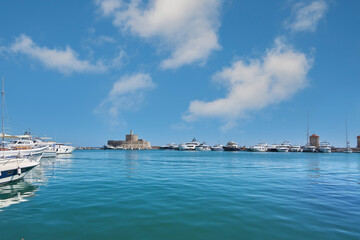 Mandraki Harbor with fortress and yachts Panoramic view of historic Rhodes port