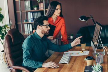 Team of professionals collaborating together in a modern office workspace, discussing project...