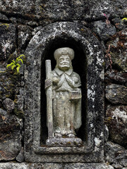sculpture of the Saint James, Santiago, as religious altar worked into the wall with stick and hat in portugal on the camino de Santiago, the road to santiago, christian pilgrimage