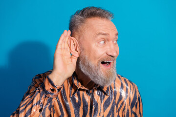 Handsome Happy Older Gentleman in Trendy Tiger Print Shirt on Blue Background