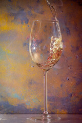 glass of white wine jumping out of the glass and splashing