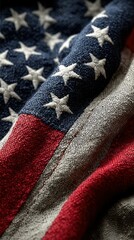 Close-up view of a weathered American flag draped gracefully displaying intricate details of fabric and colors