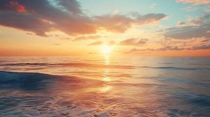 Ocean waves at sunset, illuminated by golden sunlight and a cloudy sky.