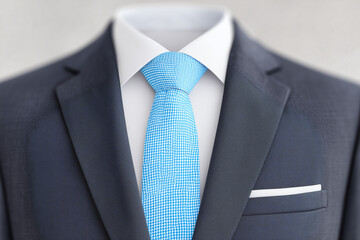 Elegant business attire, with a focused view of a suit jacket, complete with a tie and a pocket square