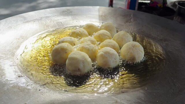 Fresh mustard oil and frying potato in round shape in pan