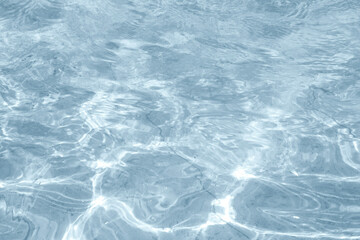 Closeup of desaturated transparent clear calm water surface texture with splashes and bubbles. 
