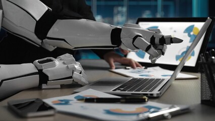 A futuristic robot hand interacts with a laptop in a modern office setting, analyzing data and...