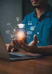 Person projecting education symbols from hands near laptop representing online learning and knowledge