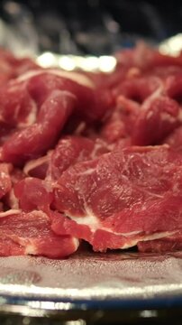Raw pieces of beef top view, rotation. Prepare beef for cooking