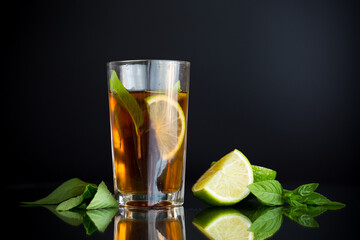 Natural fermented drink with mint and citrus on a black background