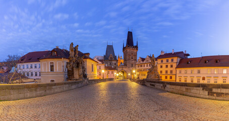 Charles Bridge with towers and sculptures at dawn in Prague, Czech Republic