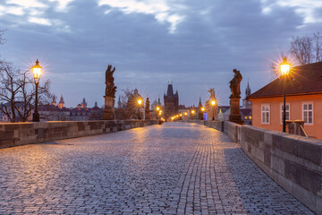 Charles Bridge with towers and sculptures at dawn in Prague, Czech Republic