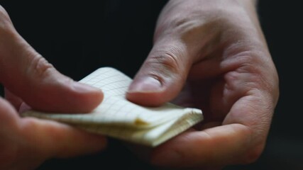 A paper ball with crumpled paper in the hands of an office worker.
A man crumples paper torn from a notebook.
Crumpled and torn paper in hands