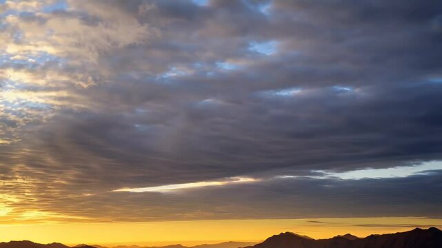 Colorful sunrise clouds over mountain range