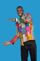 Stylish man gesturing with open hands on blue background