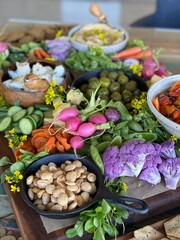 Colorful Crudité and Cheese Board with Vegetables, Nuts, and Dips