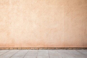 Fototapeta premium Textured peach colored wall and tiled floor creating a simple background space