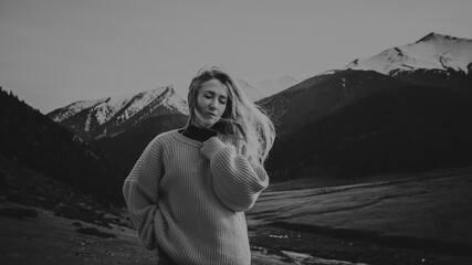 Young calm romantic woman portrait in the mountains, black and white colors