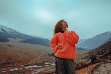 Young beautiful romantic woman portrait in the mountains in the evening