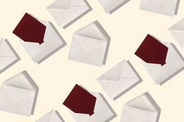 Many blank gray envelope with red blank card on pastel light background. Business or office concept