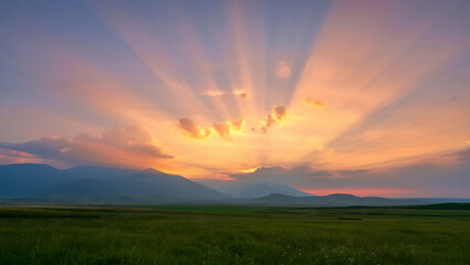 Obraz premium Dramatic mountain landscape at sunrise or sunset, featuring a panoramic view of misty hills and cloud-kissed peaks under a vibrant sky