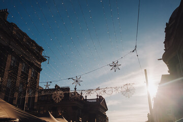 Newcastle UK: 22 Nov 2024: Christmas decorations going up Newcastle Grainger town. Newcastle prepares for festive decorations with intricate lights against the sky