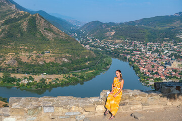 a girl sitting at the confluence of the Kura and Aragvi rivers