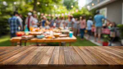 Wooden table with blurred backyard barbecue party and people socializing at sunset.

