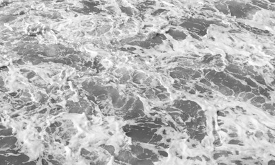 Top view. Foam on the ocean shore. Waves on the water. Contrasting image. Moody colors. Soft textured background. Mystic spring, Monotonous concrete background