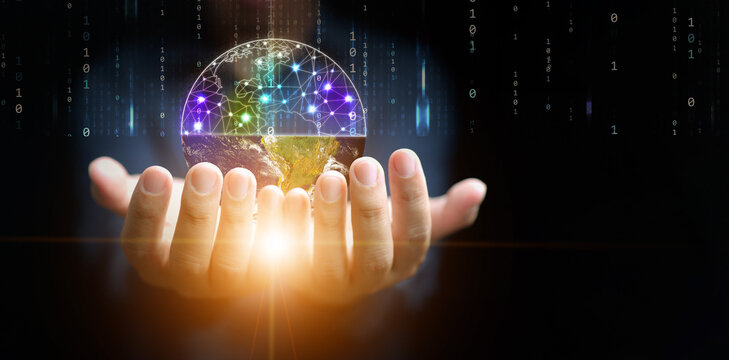 Digital twins concept. A man's hands holding a globe devided in halfs of physical and digital worlds for business and technology simulation modeling