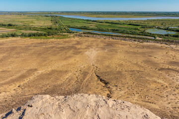 View of the Turkmenistan and Uzbekistan border with the Amu Darya river. Turkmenistan starts with the mountain in the  background