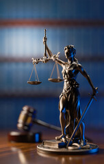 Legal Concept: Themis is the goddess of justice and the judge's gavel hammer as a symbol of law and order on the background of books