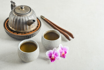 Traditional asian tea ceremony arrangement: ceramic teapot, cups and teapot tray