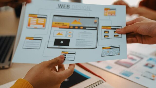 Excellent startup company employee presenting user interface prototype for mobile application or website to smart manager in office. UX UI designer pointing web page icon design and explain. Synergic