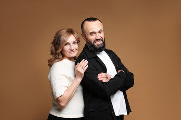 Portrait of lovely couple on brown background