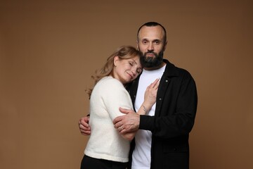 Portrait of lovely couple on brown background