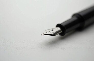 Fototapeta premium Close-up black ink fountain pen isolated on white. Pen for signature, writing letters. Elegant office stationery. Legal agreements, business contracts, official documents, handwriting.