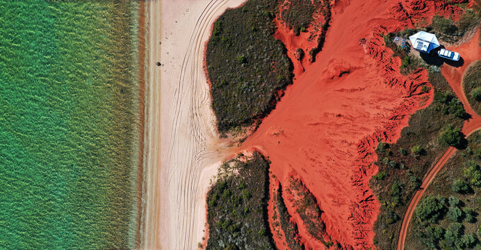 Panoramic Aerial drone landscape view of four wheel drive vehicle 4WD car and an off road caravan camping in Cape Leveque near Broome in Dampier peninsula in the Kimberley region Western Australia.