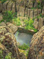 portrait view inside of canyon with granite walls and river