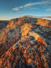sunset light on granite stones under blue sky in canyon 