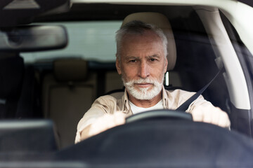 Confident Senior Man Driving Modern Car on Road Trip